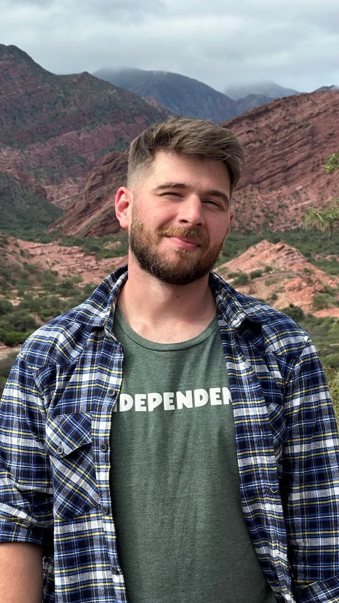 Mark Ozolin standing in the mountains